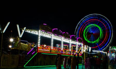 Night View of Amusement park rides, Ferris Wheel in diwali fairの写真素材
