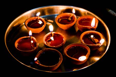 Happy Diwali - Colorful clay diya lamps lit during diwali celebrationの写真素材