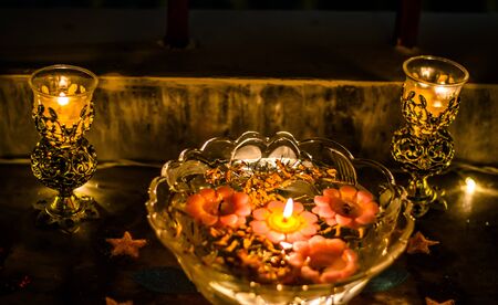 Happy Diwali - rangoli painting on floor for diwali with floating candlesの写真素材