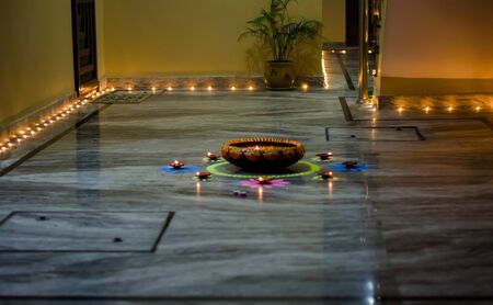 Happy Diwali - rangoli painting on floor for diwali with floating candlesの写真素材