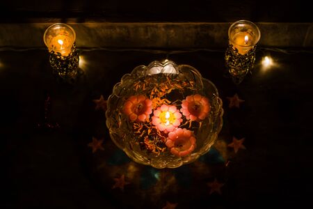 Happy Diwali - rangoli painting on floor for diwali with floating candlesの写真素材