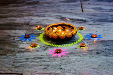 Happy Diwali - rangoli painting on floor for diwali with floating candlesの写真素材
