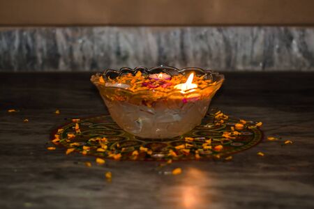 Happy Diwali - rangoli painting on floor for diwali with floating candlesの写真素材