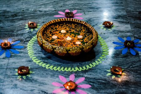 Happy Diwali - rangoli painting on floor for diwali with floating candlesの写真素材