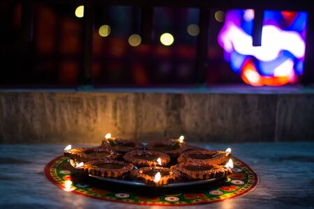 Happy Diwali - rangoli painting on floor for diwali with floating candlesの写真素材