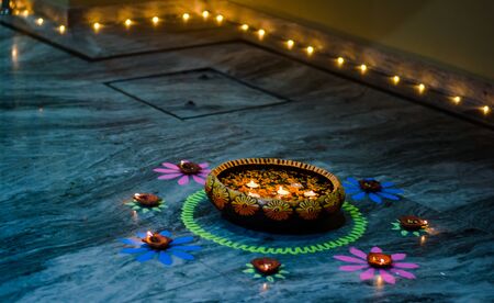 Happy Diwali - rangoli painting on floor for diwali with floating candlesの写真素材