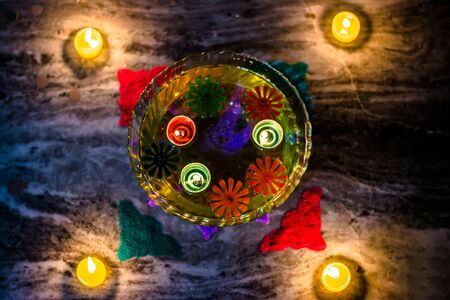 Happy Diwali - rangoli painting on floor for diwali with floating candlesの写真素材