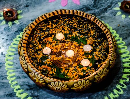 Happy Diwali - rangoli painting on floor for diwali with floating candlesの写真素材