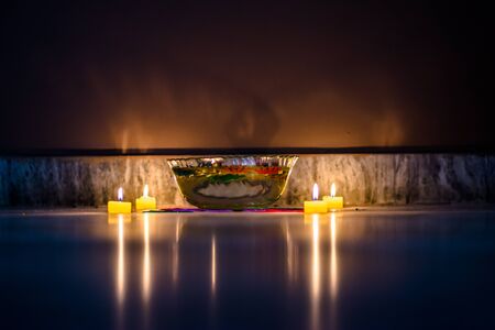 Happy Diwali - rangoli painting on floor for diwali with floating candlesの写真素材