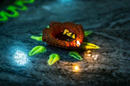 Happy Diwali - Colorful clay diya lamps lit during diwali celebrationの写真素材