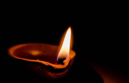 Happy Diwali - Colorful clay diya lamps lit during diwali celebrationの写真素材