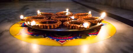 Happy Diwali - Colorful clay diya lamps lit during diwali celebrationの写真素材