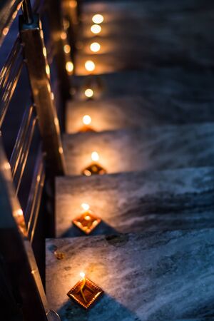 Happy Diwali - Colorful clay diya lamps lit during diwali celebrationの写真素材