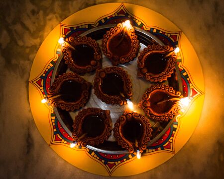 Happy Diwali - Colorful clay diya lamps lit during diwali celebrationの写真素材