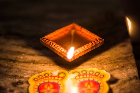 Happy Diwali - Colorful clay diya lamps lit during diwali celebrationの写真素材