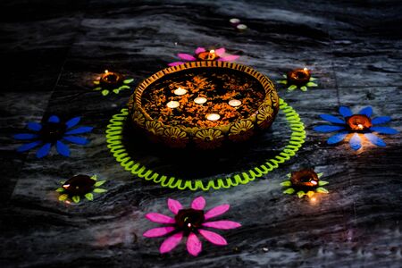 Happy Diwali - Colorful clay diya lamps lit during diwali celebrationの写真素材