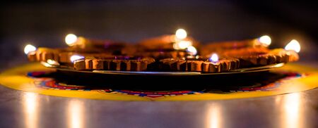 Happy Diwali - Colorful clay diya lamps lit during diwali celebrationの写真素材