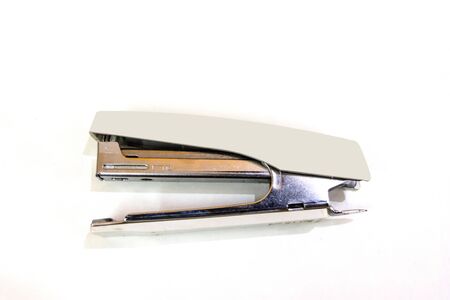 cream color stapler isolated on a white background.の写真素材