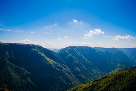 Natural view of the folded mountains and lush green valleys with clear sky and clouds of Cherrapunji, Meghalaya, North East Indiaの写真素材