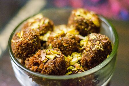 Fresh Homemade ladoo or laddu, made by bread crumbs with pistachio on it, with selective focusの写真素材