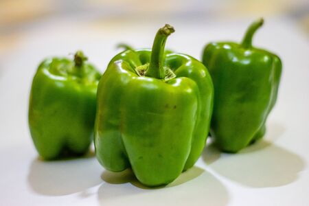 Fresh green capsicum or bell pepper isolated on a white backgroundの写真素材