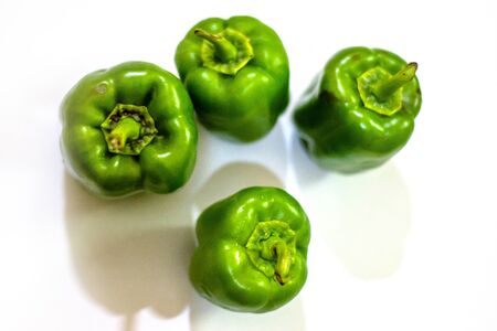 Fresh green capsicum or bell pepper isolated on a white backgroundの写真素材