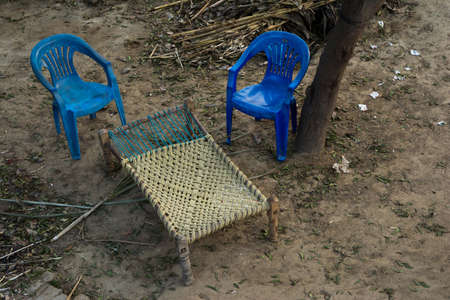 charpai - traditional Indian style bed made of woven net or rope mesh. desi bed with two chairs. Aerial viewの写真素材