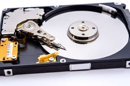 Internal parts of a hard disk isolated on a white background. Close up of Hard disk drive inside view.の写真素材