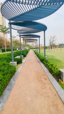 Pathway and track for running or walking in the park on park field on the side. Beautiful track on park with blue sky.の写真素材