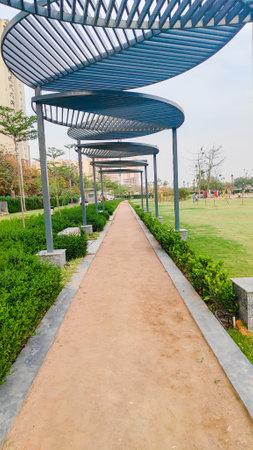 Pathway and track for running or walking in the park on park field on the side. Beautiful track on park with blue sky.の写真素材