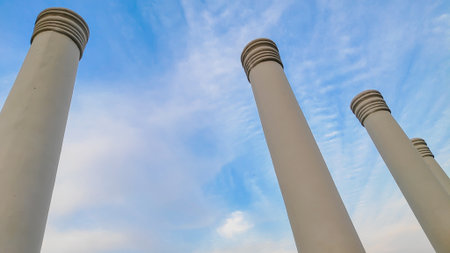 An architectural close-up of pillars touching  the blue sky. Touching the sky.の写真素材