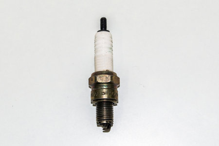 Spark plug for cars and bike on an isolated white background. Copper spark plugs. Spark plugs with...
