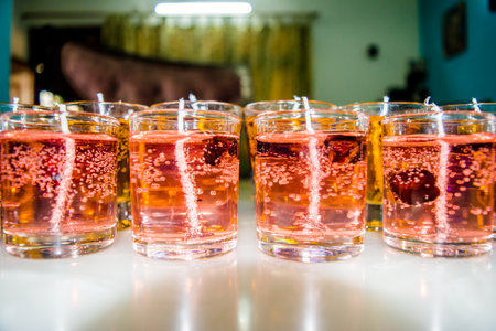 Gel candle in glass isolated on white background. set of colored gel candles. Candle in glass with many colored candles.の写真素材