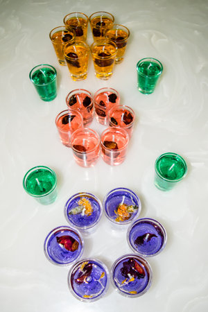 Gel candle in glass isolated on white background. set of colored gel candles. Candle in glass with many colored candles.の写真素材