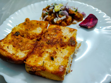 Mumbai Style Pav Bhaji, Indian spicy fast food with bread, onion and butter. Pav bhaji is a fast food dish from India consisting of a thick vegetable curry served with a soft bread rollの写真素材