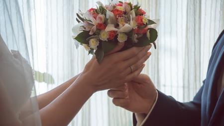 wedding bouquet pass each other the husband and the bride giftの写真素材