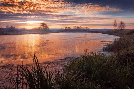 autumn sunrise on the river in October dayの写真素材