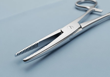 Close-up of dental tweezers on a blue background.の素材