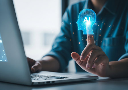 A close-up shot of a person interacting with a glowing blue AI head hologram emerging from a laptop screen, highlighting the integration of artificial intelligence in modern technology.の素材