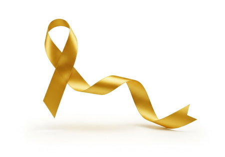 A lustrous golden ribbon, elegantly tied into a bow, gracefully curves and twists, isolated against a stark white background, symbolizing hope and awareness.の素材