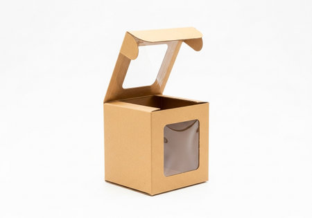A single, small, open brown cardboard box with a clear plastic window on its front and lid, presented against a plain white background.の素材