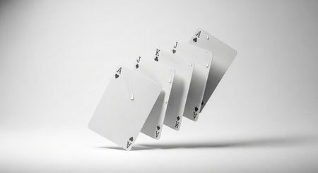 A minimalist composition featuring four playing card aces, artfully arranged in a fanned sequence against a clean, bright white backdrop.の素材