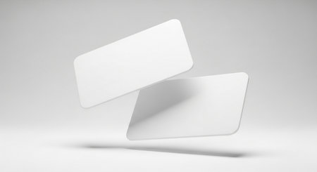 A pair of pristine white cards suspended mid-air, showcasing a clean and minimalist aesthetic perfect for showcasing branding or promotional designs.の素材