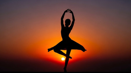 Silhouette of a ballerina on the sunset background.の素材