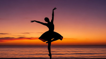 A lone ballerina in silhouette performs a graceful dance pose against a vibrant sunset sky over the ocean.の素材