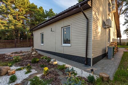 modern eco country house in a pine forest at sunsetの写真素材