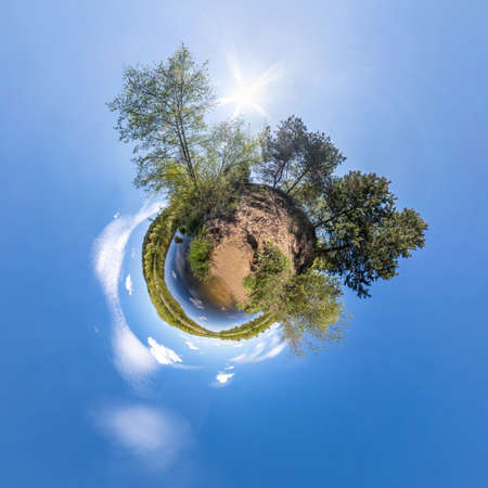Little planet transformation of spherical panorama 360 degrees. Spherical abstract aerial view in field with clear sky and awesome beautiful clouds. Curvature of space.の写真素材