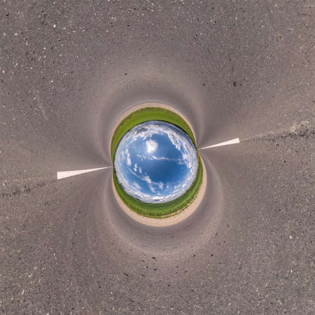 Inversion of blue little planet transformation of spherical panorama 360 degrees. Spherical abstract aerial view on field with awesome beautiful clouds. Curvature of space.の写真素材