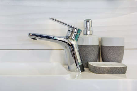 Ceramic Water tap sink with faucet with soap and shampoo dispensers in expensive loft bathroom or kitchenの写真素材