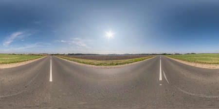 Full spherical seamless panorama 360 degrees angle view on no traffic old asphalt road among fields with clear sky and white clouds in equirectangular projection, VR AR contentの写真素材